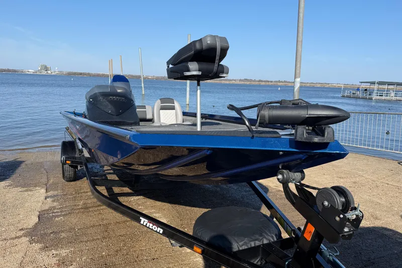 Slide: The Image of 2020 Triton 17 TX boat on trailer by the water, ready for launch. - 1