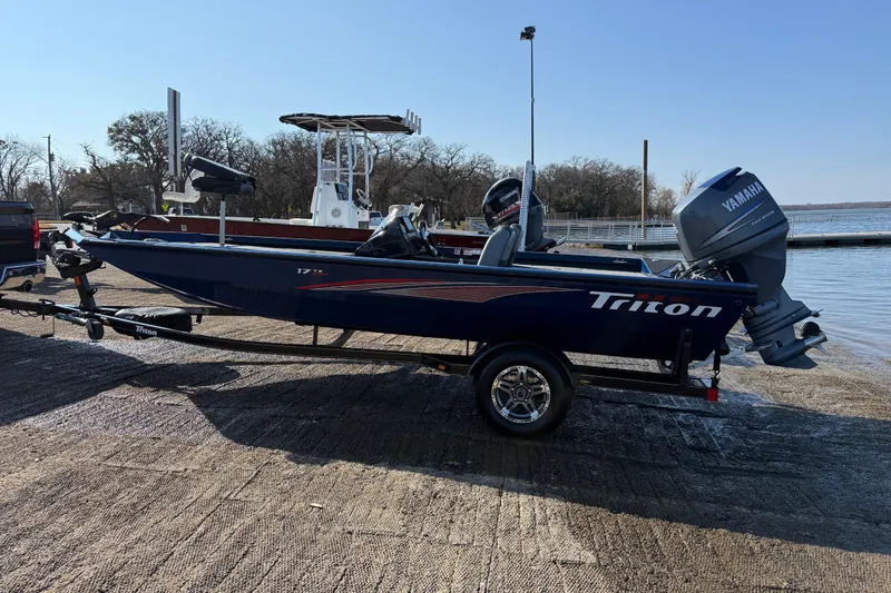 Slide: The Image of 2020 Triton 17 TX boat with Yamaha motor on trailer by a lake. - 11