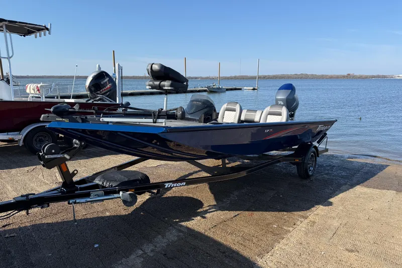 Slide: The Image of 2020 Triton 17 TX boat on trailer by a lake, ready for launch. - 14