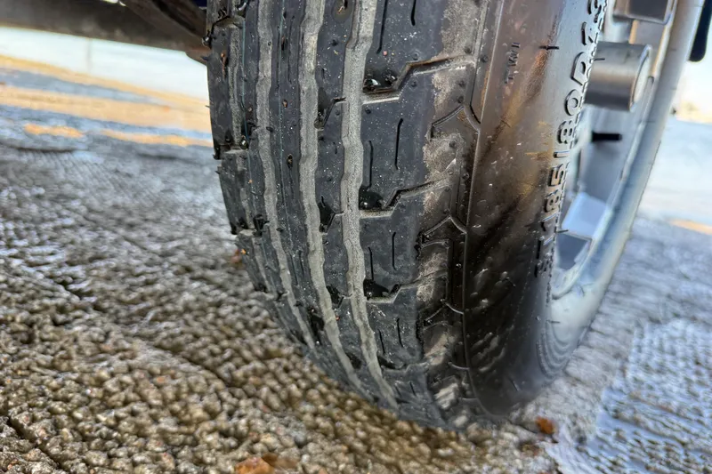 Slide: The Image of Close-up of a 2020 Triton 17 TX tire on textured pavement. - 22