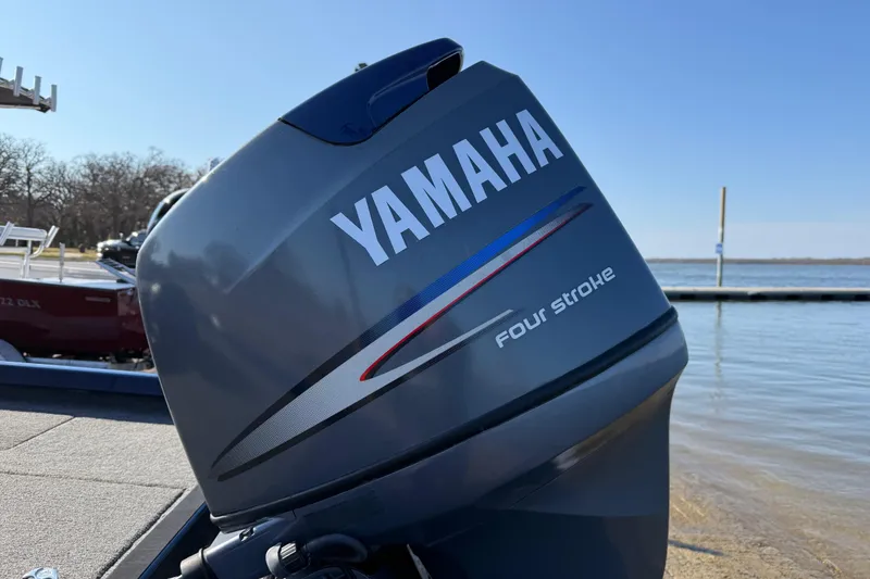 Slide: The Image of Yamaha four-stroke engine on 2020 Triton 17 TX boat by the water. - 23