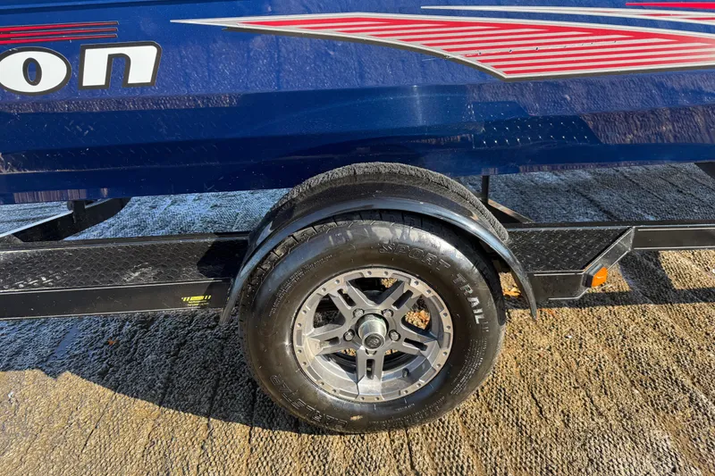 Slide: The Image of 2020 Triton 17 TX boat trailer with Sport Trail tire on a sunny day. - 25
