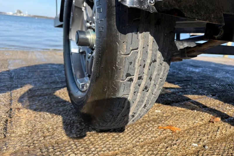 Slide: The Image of Close-up of a 2020 Triton 17 TX trailer tire on a wet boat ramp. - 26