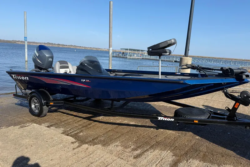 Slide: The Image of 2020 Triton 17 TX boat on trailer by the water, featuring Yamaha engine. - 3