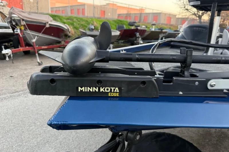 Slide: The Image of Minn Kota Edge motor on 2020 Triton 17 TX boat, parked outdoors. - 35