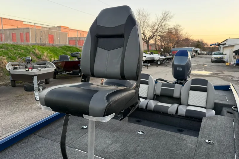 Slide: The Image of 2020 Triton 17 TX boat with black and gray seating, parked outdoors. - 37