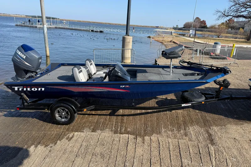 Slide: The Image of 2020 Triton 17 TX boat with Yamaha motor on trailer by the water. - 4