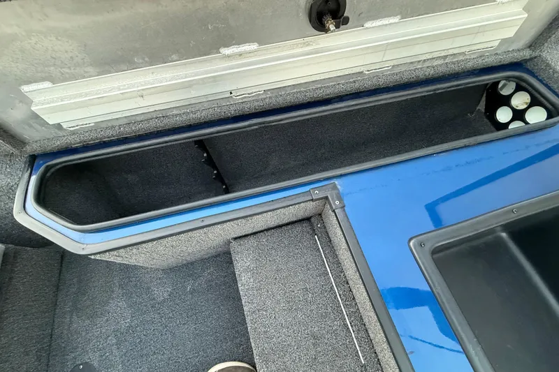 Slide: The Image of 2020 Triton 17 TX boat interior storage compartment with blue and gray finish. - 42