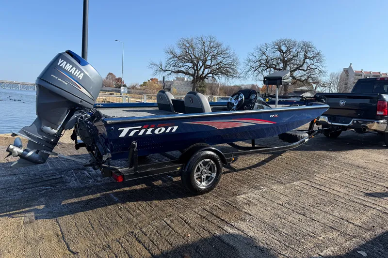 Slide: The Image of 2020 Triton 17 TX boat with Yamaha motor on trailer by a lakeside. - 5