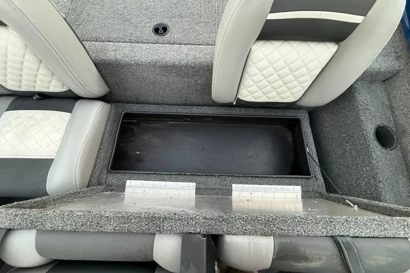 Slide: The Image of 2020 Triton 17 TX boat interior with storage compartment and quilted seats. - 50