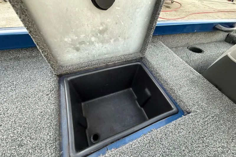 Slide: The Image of Open storage compartment in 2020 Triton 17 TX boat, featuring carpeted interior. - 52
