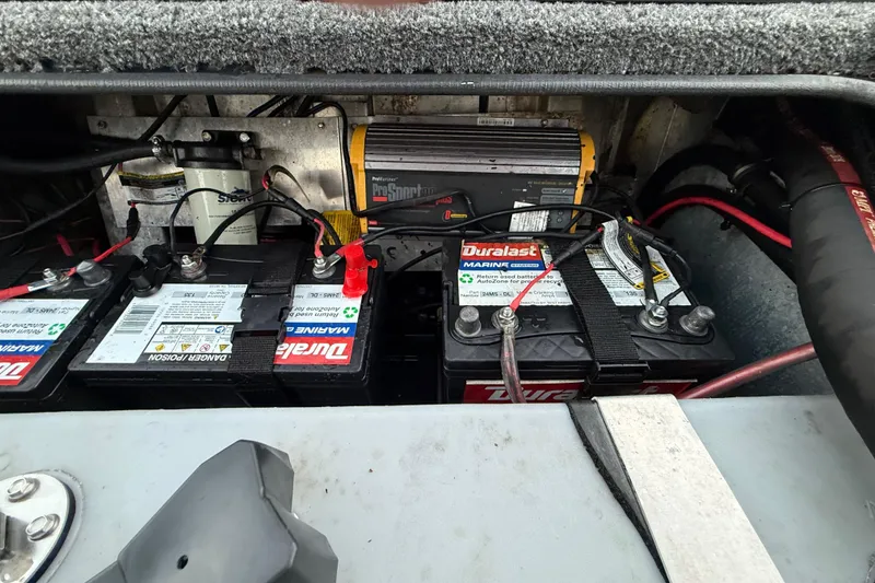 Slide: The Image of Marine batteries and charger setup in a 2020 Triton 17 TX boat. - 53