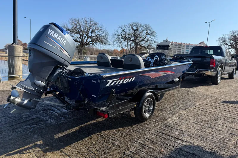 Slide: The Image of 2020 Triton 17 TX boat with Yamaha engine on trailer, parked near water. - 6