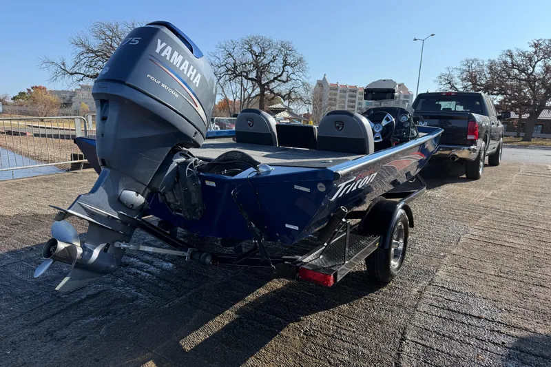 Slide: The Image of 2020 Triton 17 TX boat with Yamaha outboard motor on trailer, parked near water. - 7