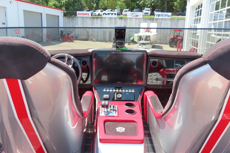 Slide: The Image of Interior of a 2018 Wright Performance 360 boat with modern dashboard and seating. - 11