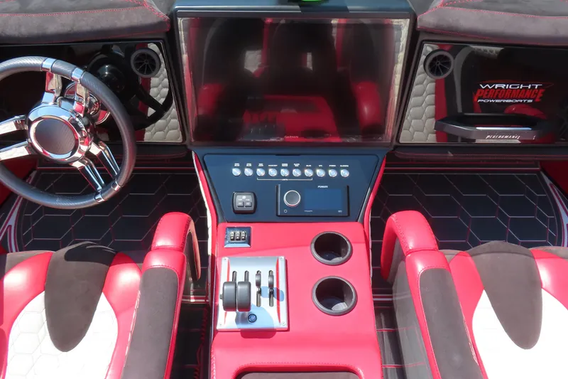 Slide: The Image of Red and black interior of 2018 Wright Performance 360 boat with modern controls and steering wheel. - 13