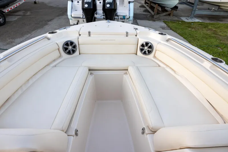Slide: The Image of 2021 Grady-White Freedom 215 boat interior with cushioned seating and speakers. - 12