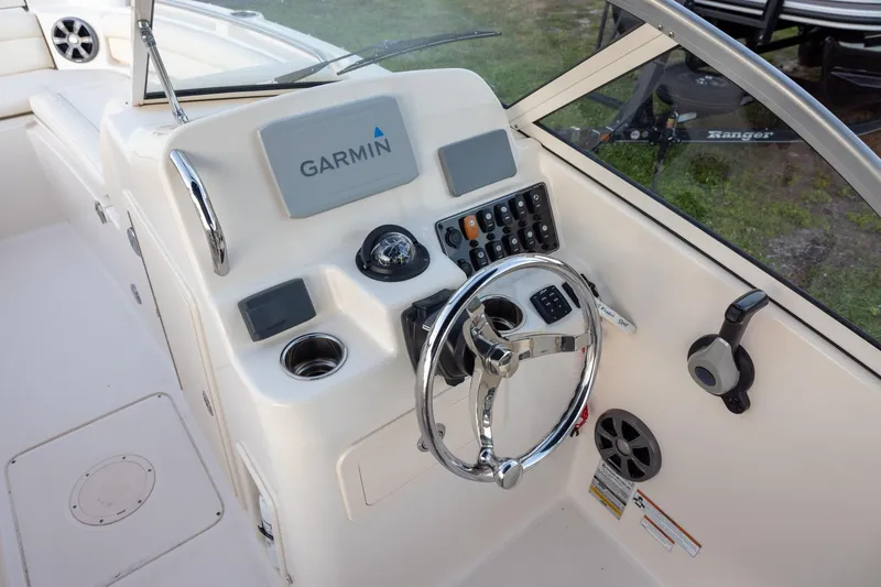 Slide: The Image of 2021 Grady-White Freedom 215 boat dashboard with Garmin navigation system and steering wheel. - 8