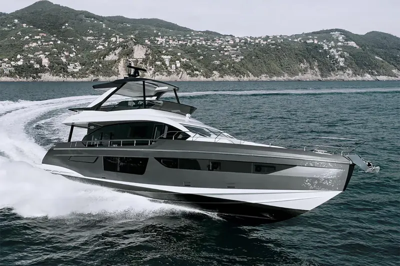 The Image of Manufacturer Provided Image: 2025 Azimut Fly 68 yacht cruising on open water with scenic coastal backdrop. - 0