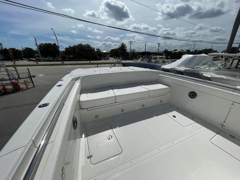 Slide: The Image of 2024 World Cat 400 CC-X boat with spacious seating area and storage compartments. - 12