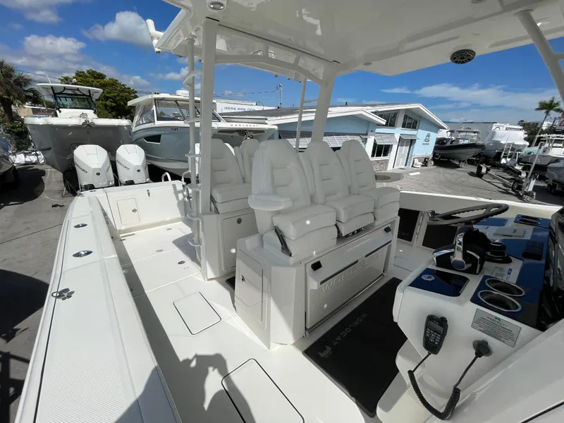 Slide: The Image of 2024 World Cat 400 CC-X boat interior with white seating and control panel. - 16