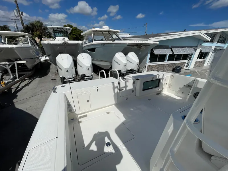 Slide: The Image of 2024 World Cat 400 CC-X boat with triple outboard engines in a marina. - 3