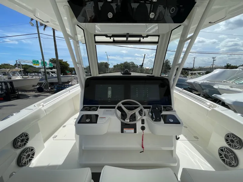Slide: The Image of 2024 World Cat 400 CC-X boat helm with modern controls and spacious seating. - 5