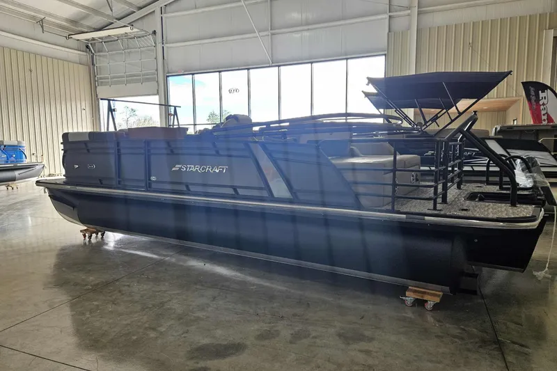 The Image of 2026 Starcraft SLS 3 Q DH pontoon boat in showroom, featuring sleek design and modern amenities. - 1