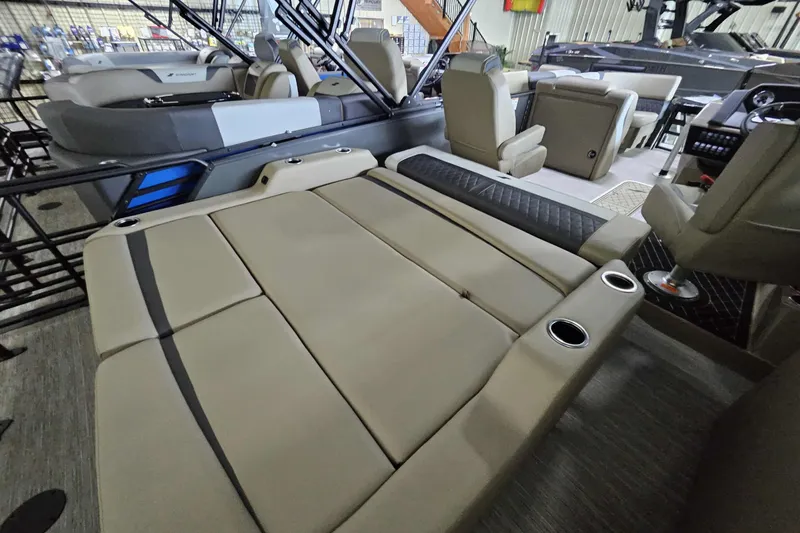 Slide: The Image of 2026 Starcraft SLS 3 Q DH boat interior with beige seating and cup holders. - 10
