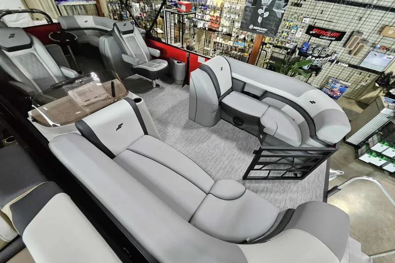 Slide: The Image of 2026 Starcraft SLS 3 Q DH boat interior with modern seating and helm in showroom. - 15
