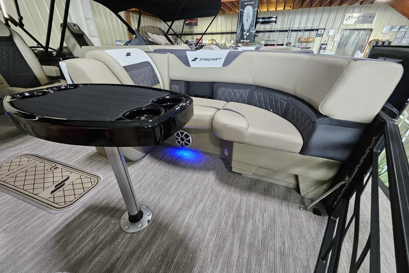 Slide: The Image of Luxurious interior of 2026 Starcraft SLS 3 Q DH pontoon boat with elegant seating and table. - 4