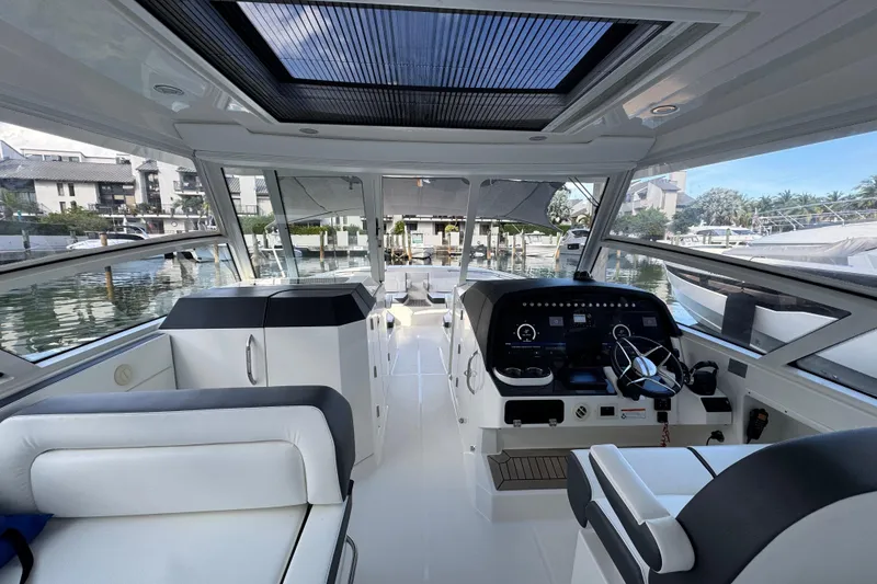 Slide: The Image of Interior of 2023 World Cat 400 DC-X boat, featuring modern helm and seating. - 16
