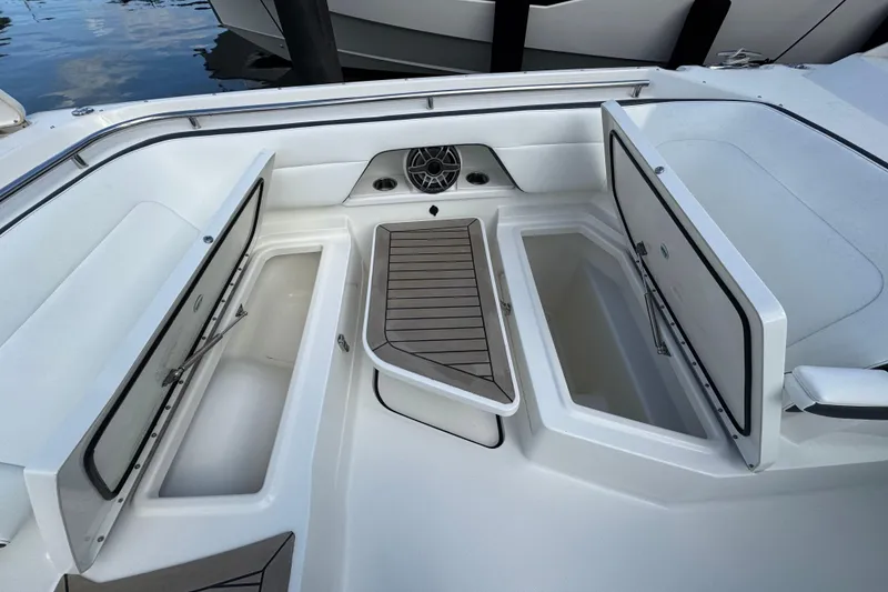 Slide: The Image of 2023 World Cat 400 DC-X boat interior with open storage compartments and seating. - 19