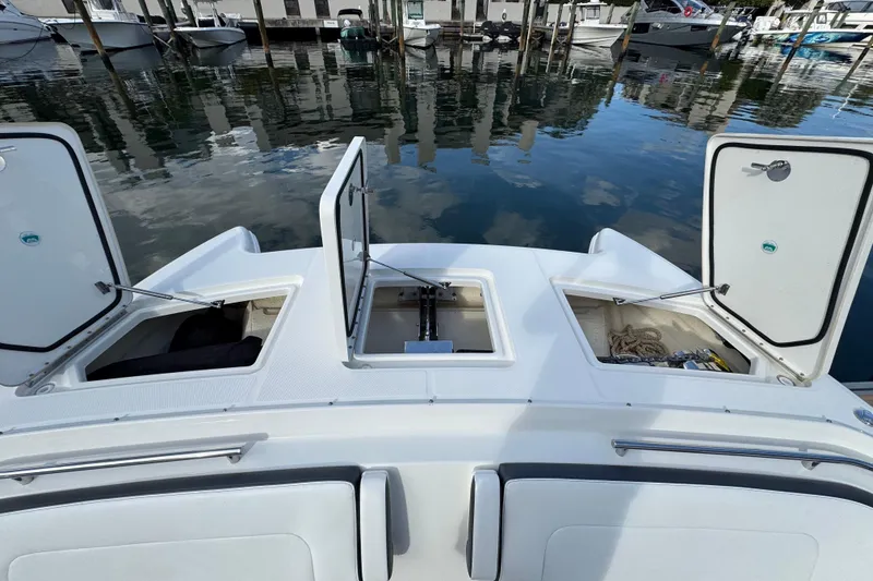 Slide: The Image of 2023 World Cat 400 DC-X boat with open storage compartments at marina. - 23