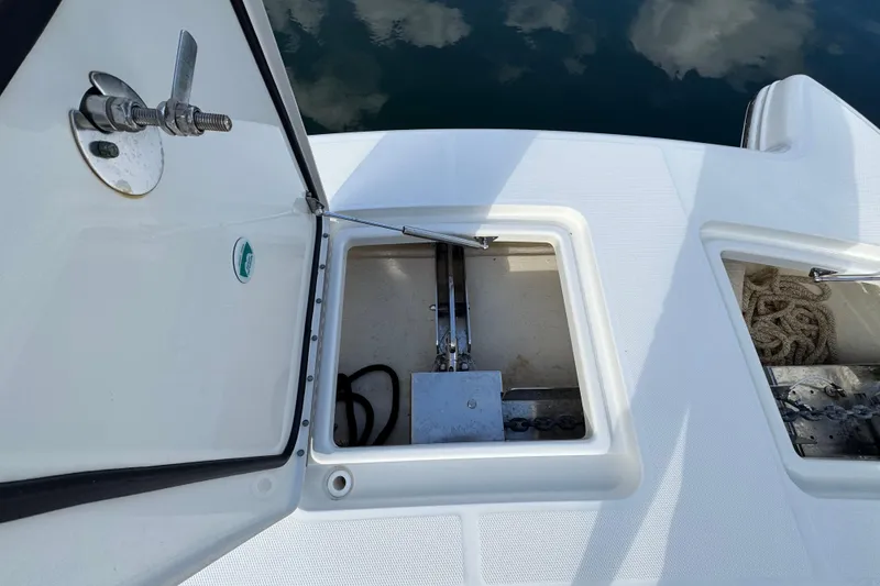 Slide: The Image of Open storage compartments on a 2023 World Cat 400 DC-X boat, showing anchor and rope. - 24