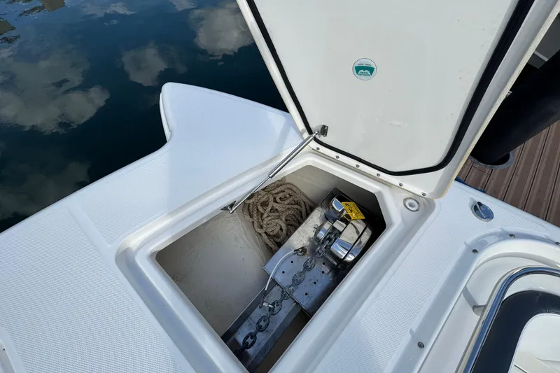 Slide: The Image of 2023 World Cat 400 DC-X boat anchor compartment with rope and chain. - 25