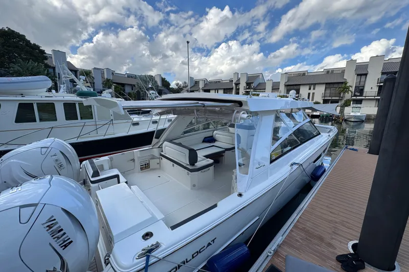 Slide: The Image of 2023 World Cat 400 DC-X boat docked, featuring Yamaha engines, under a partly cloudy sky. - 3