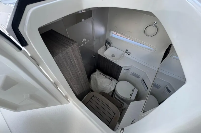 Slide: The Image of 2023 World Cat 400 DC-X boat interior with sink, toilet, and storage. - 32
