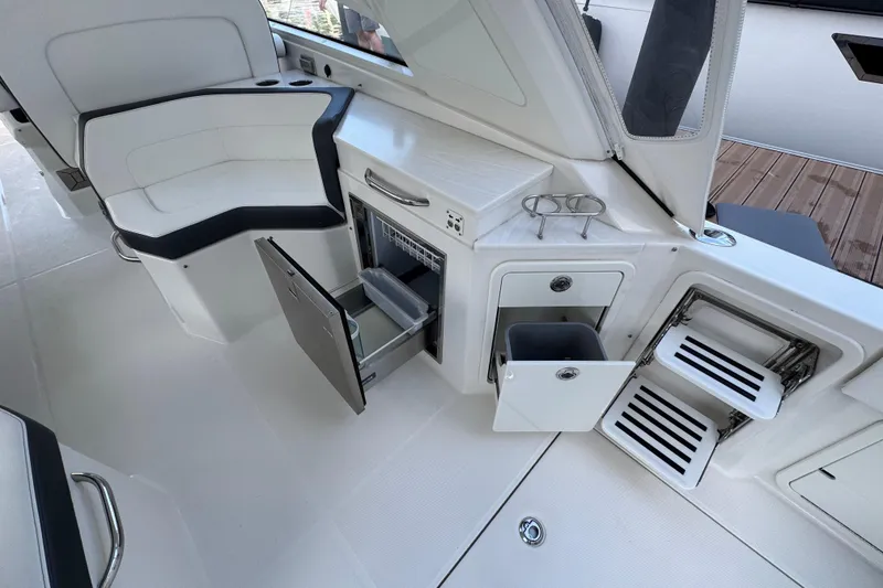 Slide: The Image of Interior of 2023 World Cat 400 DC-X boat with seating and storage compartments. - 34