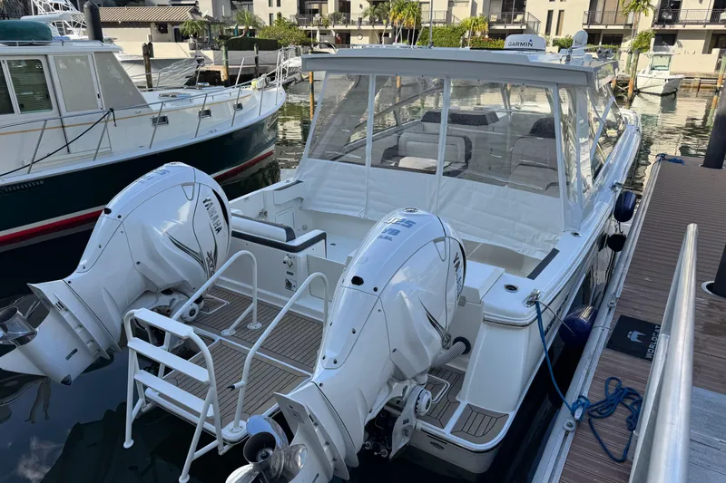 Slide: The Image of 2023 World Cat 400 DC-X boat docked with dual Yamaha outboard engines. - 4
