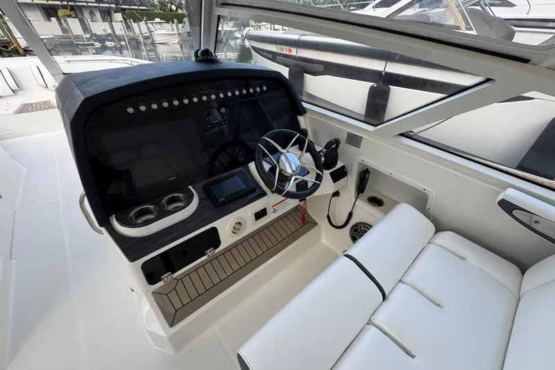 Slide: The Image of Cockpit of 2023 World Cat 400 DC-X boat with modern controls and seating. - 5