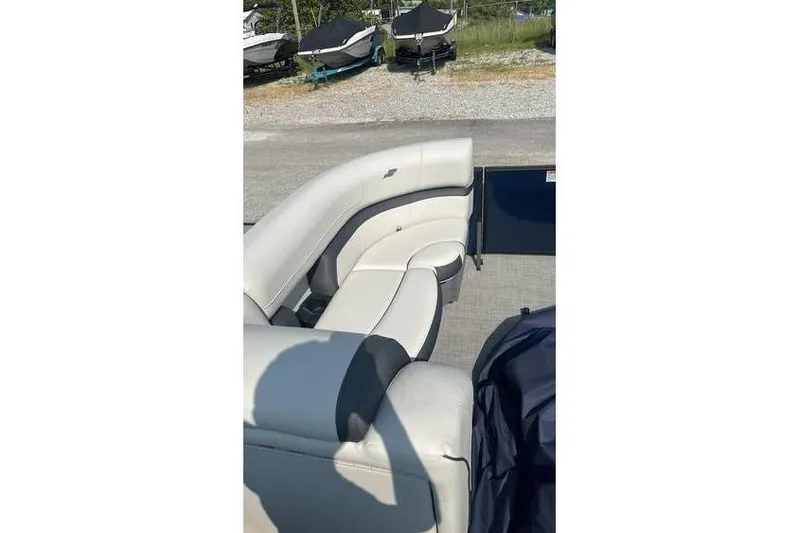 Slide: The Image of 2024 Starcraft EXS 3 Q boat interior with white seating and outdoor setting. - 5