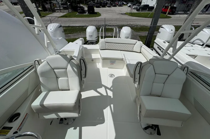 Slide: The Image of 2026 World Cat 230 SD boat interior with white seating and dual outboard motors. - 10