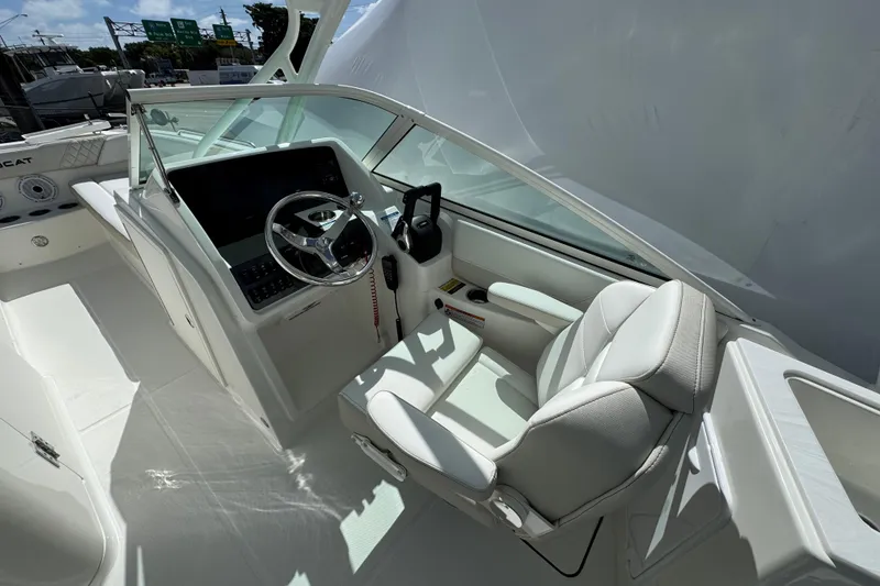 Slide: The Image of Interior of 2026 World Cat 230 SD boat, featuring modern helm and seating. - 13
