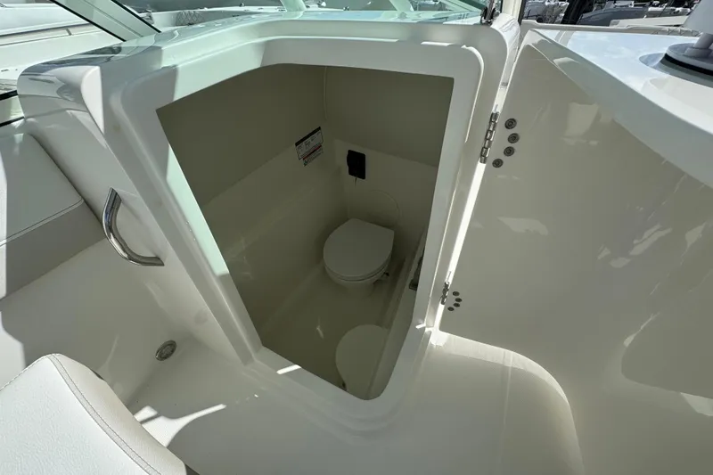 Slide: The Image of Interior view of 2026 World Cat 230 SD boat's compact bathroom. - 16