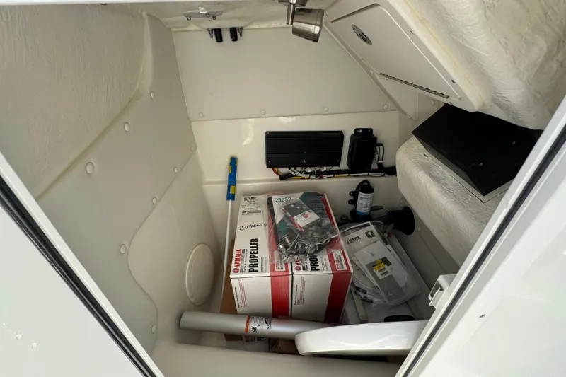 Slide: The Image of Storage compartment of 2026 World Cat 230 SD boat with Yamaha propeller box. - 18