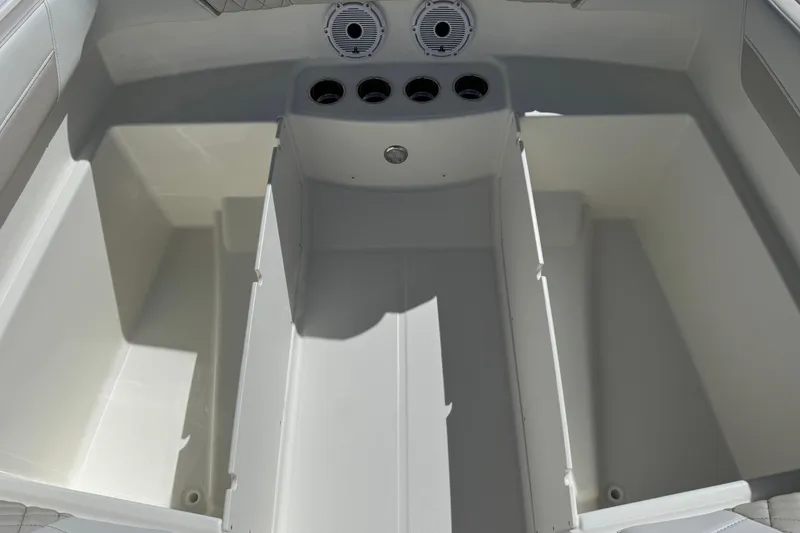 Slide: The Image of 2026 World Cat 230 SD boat interior storage compartments and cup holders. - 20