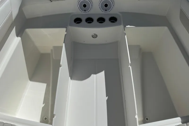 Slide: The Image of 2026 World Cat 230 SD boat interior storage compartments with cup holders and speaker. - 21