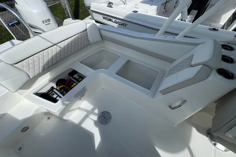 Slide: The Image of 2026 World Cat 230 SD boat interior with seating, storage, and cup holders. - 22