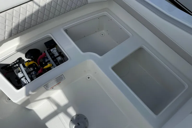 Slide: The Image of 2026 World Cat 230 SD boat storage compartments and battery setup. - 23